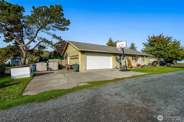 a view of a house with a yard and garage