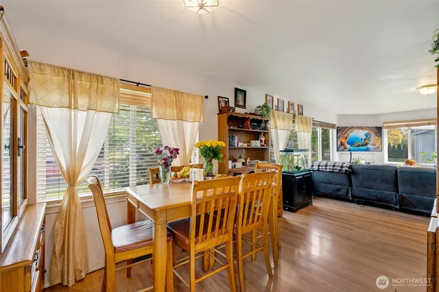 a dining room with furniture and wooden floor