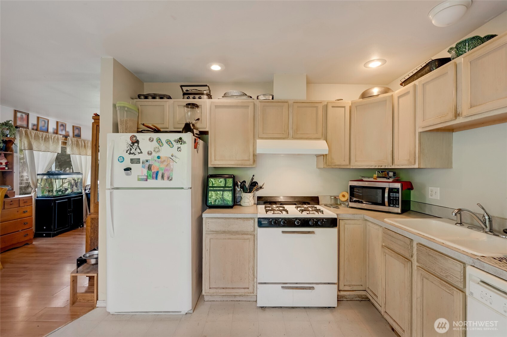 319 6th Street Blaine, WA 98230 - Photo 9 of 24 a kitchen with white cabinets and white appliances