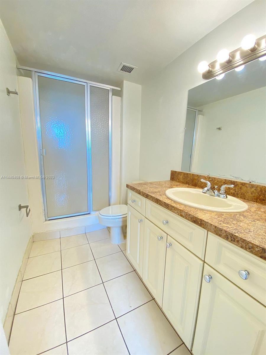 13499 Biscayne Boulevard, Unit 1408 North Miami, FL 33181 - Photo 14 of 24 a bathroom with a sink a vanity and a mirror