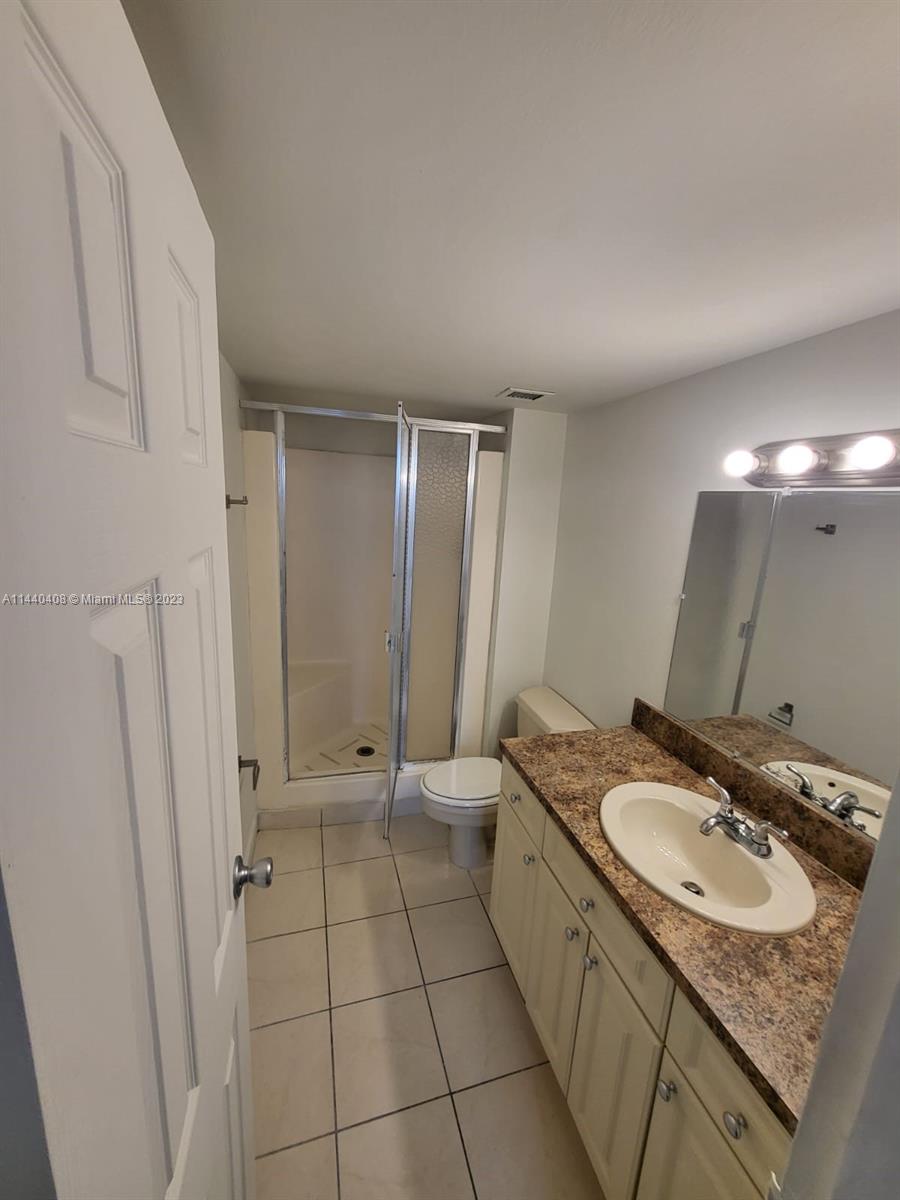 13499 Biscayne Boulevard, Unit 1408 North Miami, FL 33181 - Photo 21 of 24 a bathroom with a sink toilet and shower