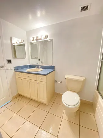 a bathroom with a sink toilet and a mirror
