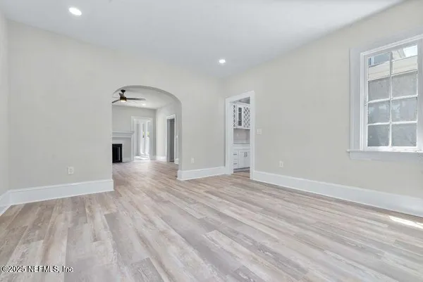 a view of a hallway with wooden floor and entryway