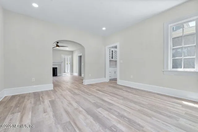 a view of a hallway with wooden floor and entryway
