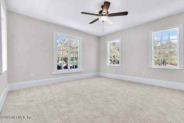 an empty room with closet and windows