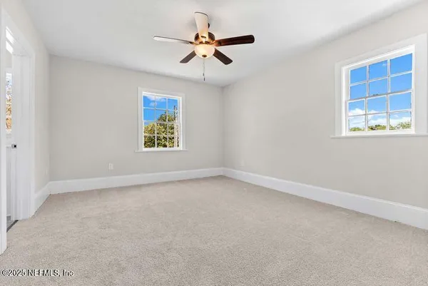 a house that has a tree in front of it