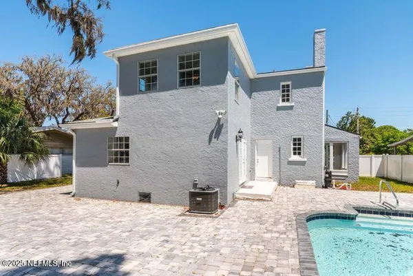 a view of a house with a yard covered in snow