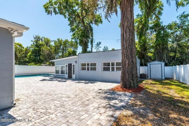 a view of an empty room with wooden floor and entryway