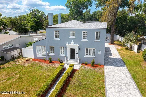 a view of a house with pool and chairs