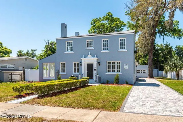 a view of a hallway with wooden floor and a fireplace