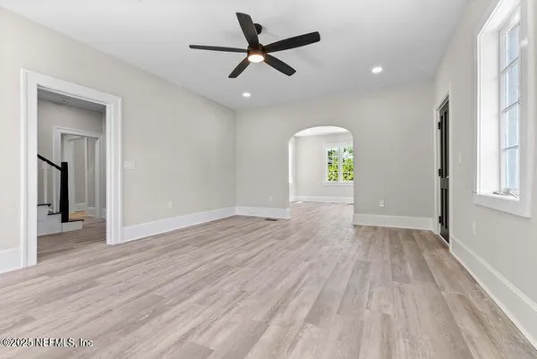 a view of an empty room with a fireplace and a large window