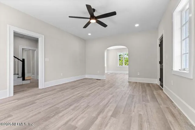 a view of an empty room with a fireplace and a large window