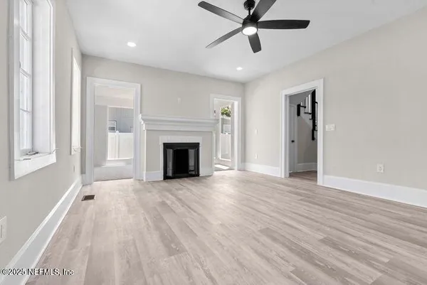 wooden floor in an empty room with a window