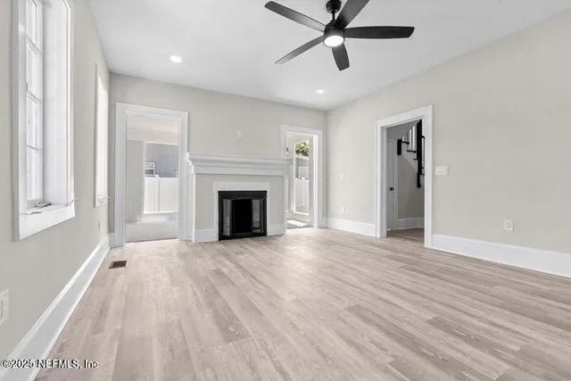 wooden floor in an empty room with a window