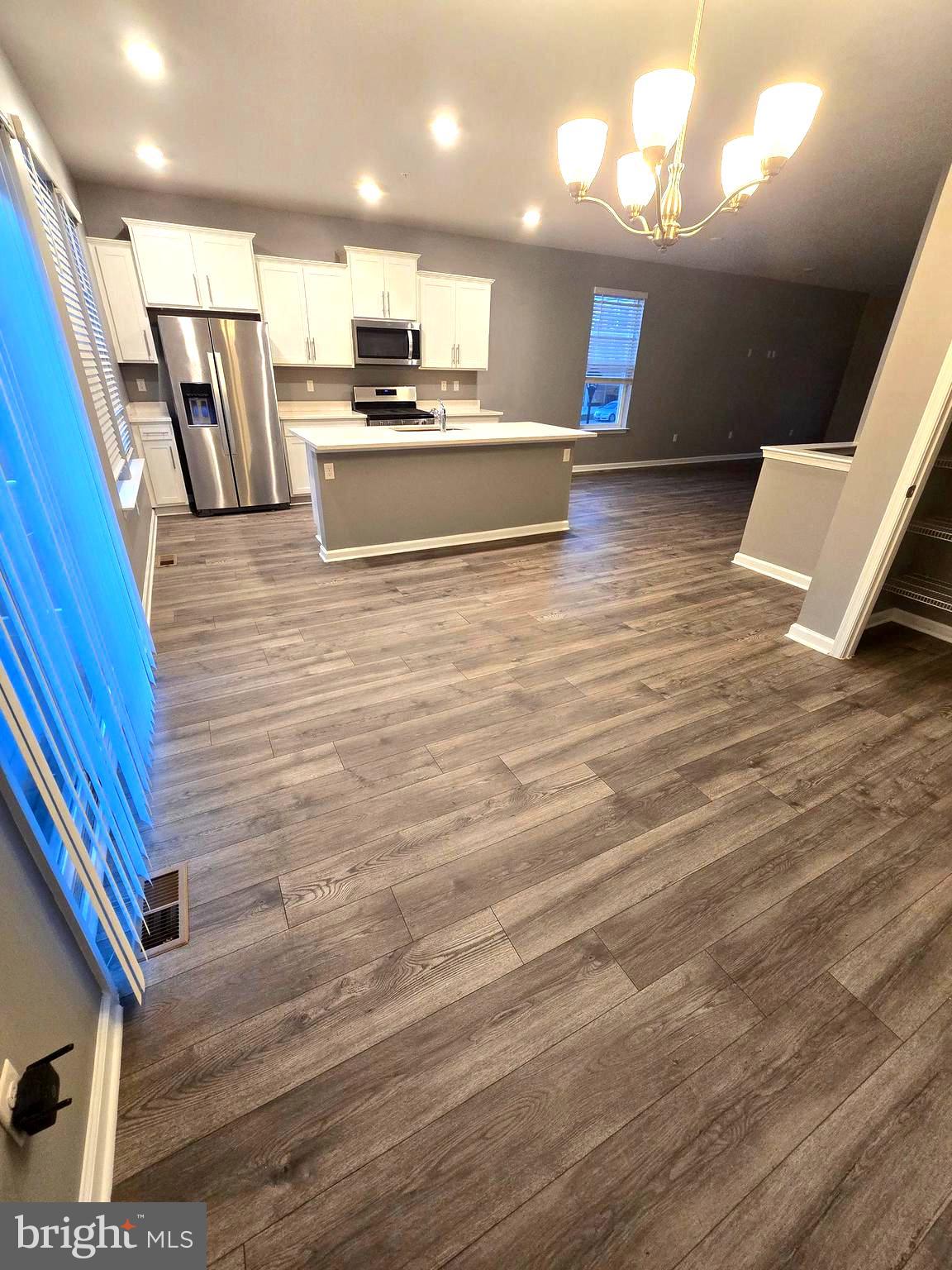 2118 Ruby Turn Bowie, MD 20721 - Photo 2 of 24 a large white kitchen with wooden floors and stainless steel appliances