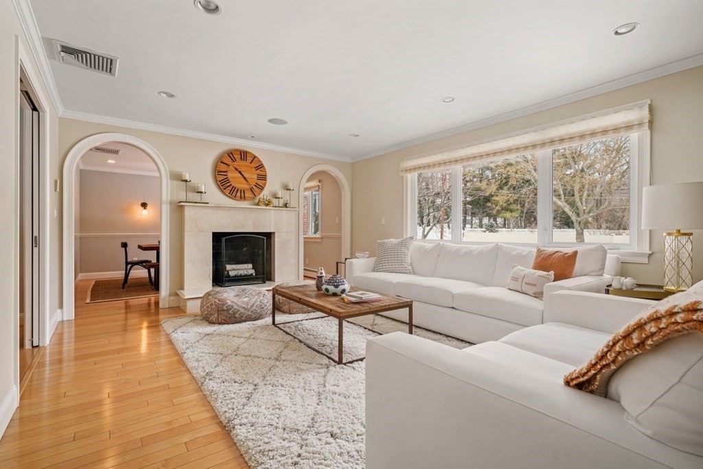 8 Eastham Road Newton, MA 02459 - Photo 3 of 30 a living room with furniture a large window and a fireplace