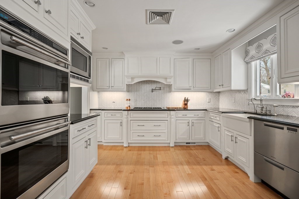 8 Eastham Road Newton, MA 02459 - Photo 8 of 30 a kitchen with granite countertop white cabinets and white appliances