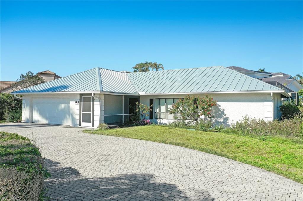 601 Park Shore Drive Naples, FL 34103 - Photo 4 of 18 a front view of a house with a yard