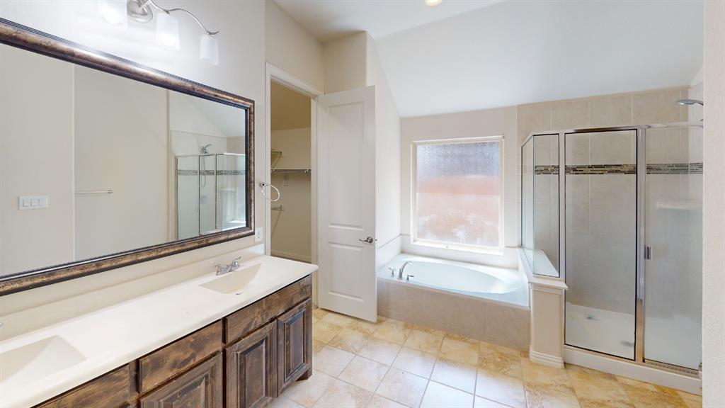 14712 Spitfire Trail Fort Worth, TX 76262 - Photo 11 of 25 Bathroom featuring a dual vanity with a framed mirror, a separate soaking tub, a stand-up shower with glass enclosure, and tiled flooring