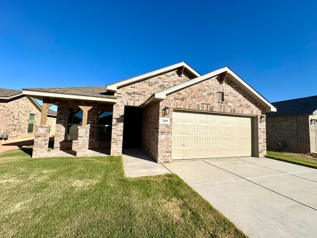a view of a house with a yard and garage