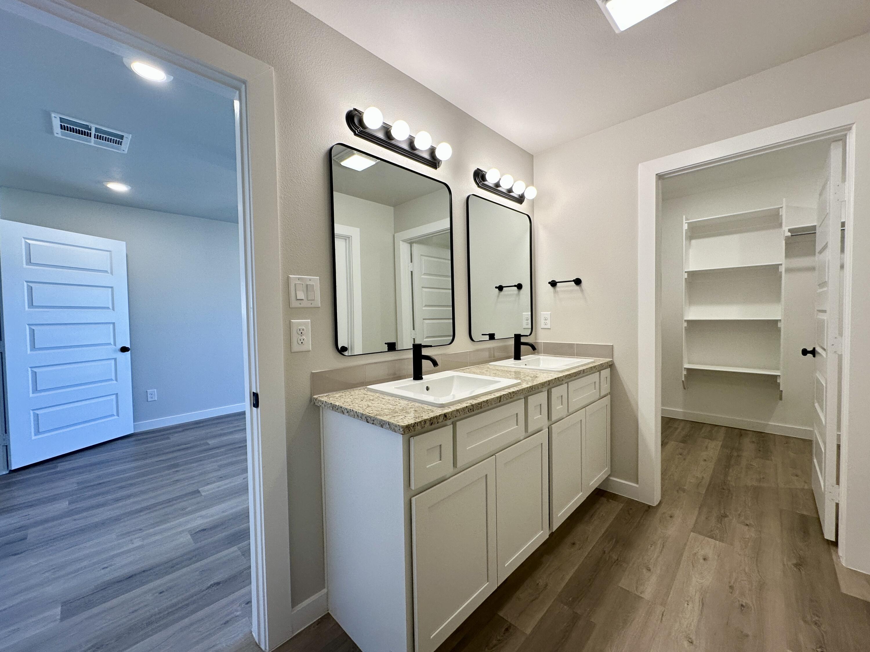 2208 134th Street Lubbock, TX 79423 - Photo 11 of 17 a bathroom with a sink and a mirror