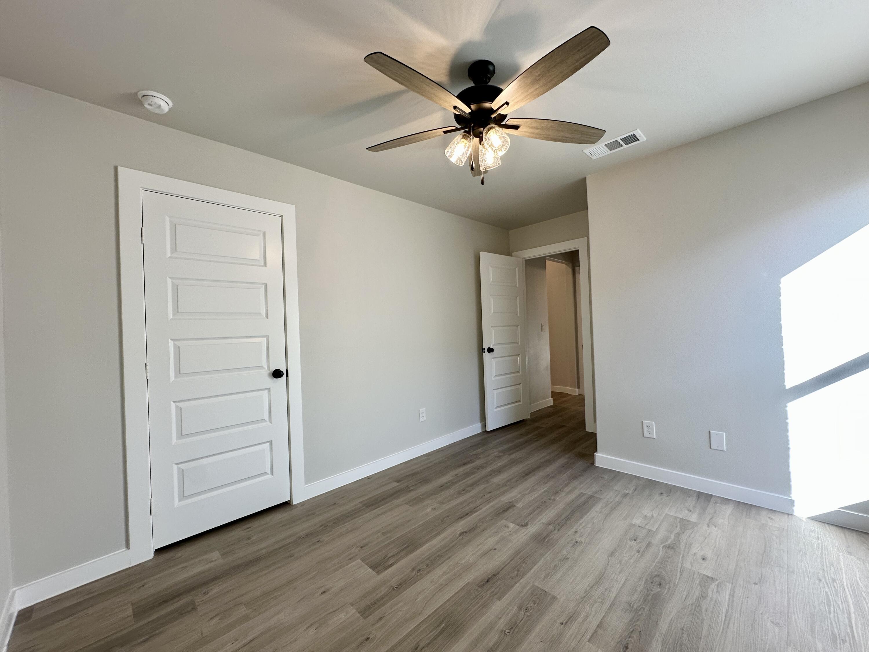 2208 134th Street Lubbock, TX 79423 - Photo 16 of 17 wooden floor in an empty room with a window
