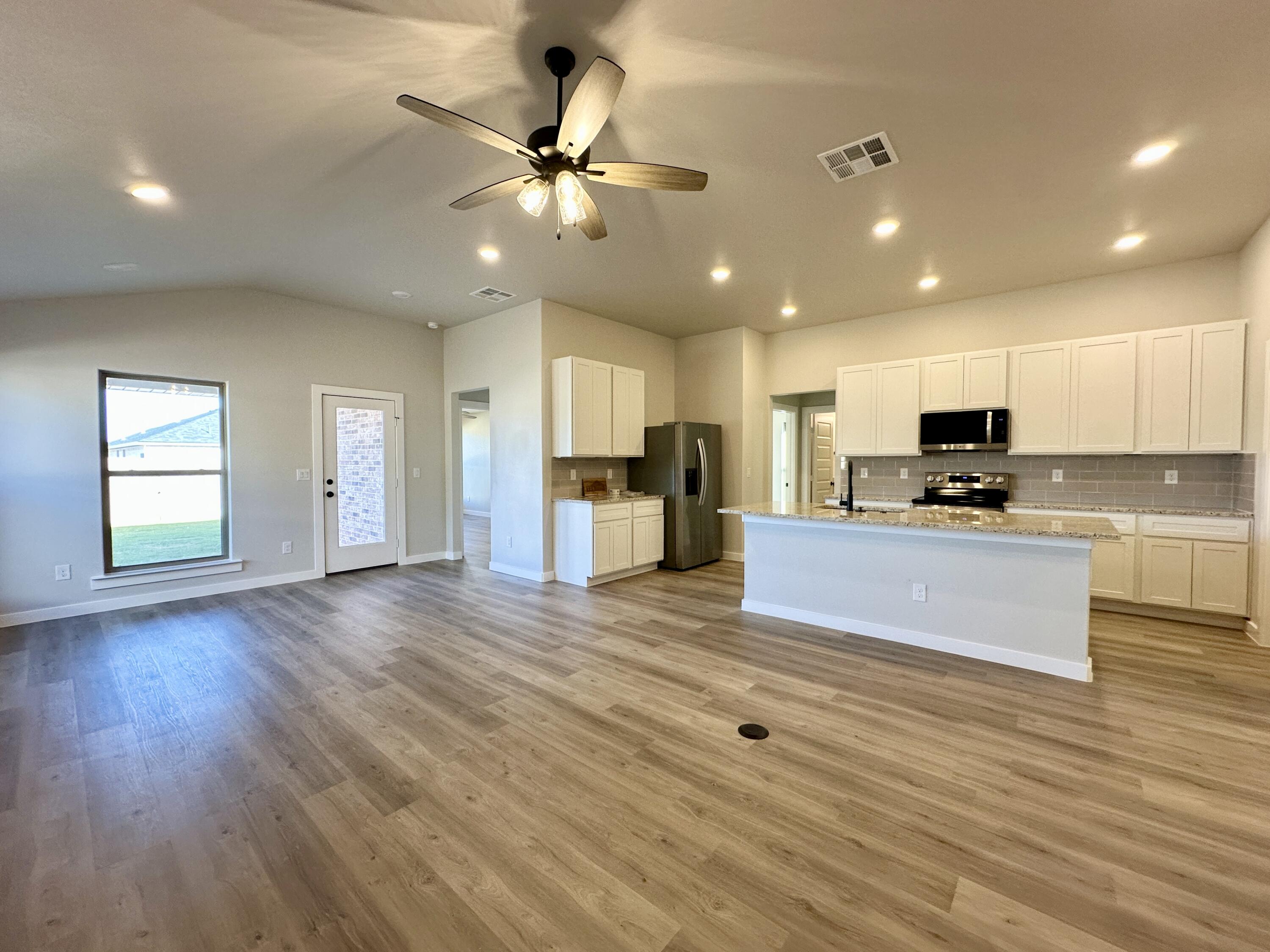 2208 134th Street Lubbock, TX 79423 - Photo 3 of 17 a view of kitchen with cabinets and wooden floor
