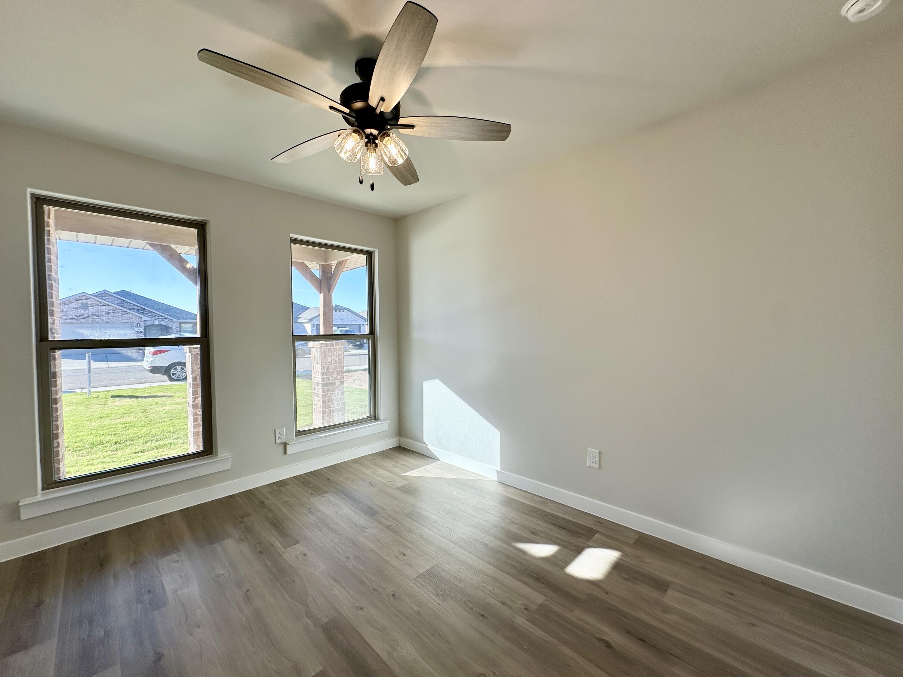 2208 134th Street Lubbock, TX 79423 - Photo 5 of 17 wooden floor in an empty room with a window