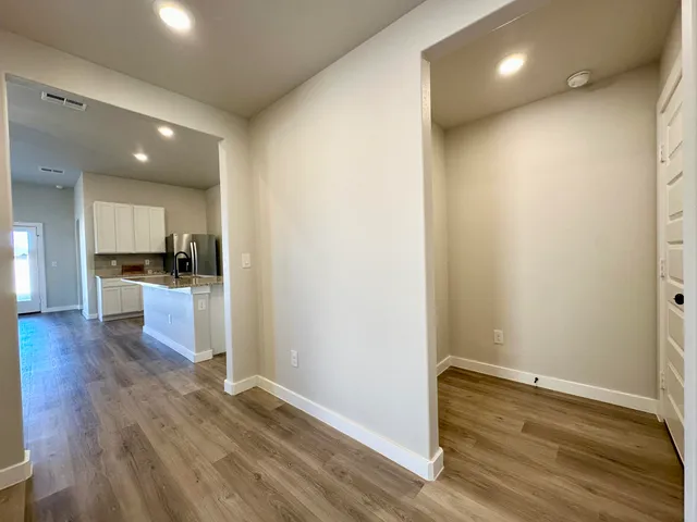 a view of kitchen with cabinets and wooden floor