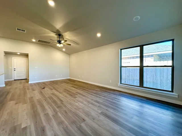 a view of an empty room with a window