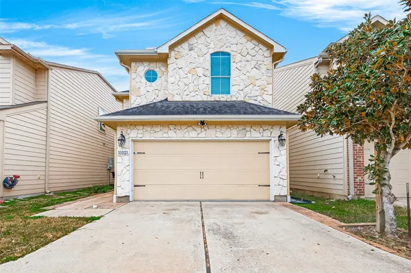 a front view of a house with garage