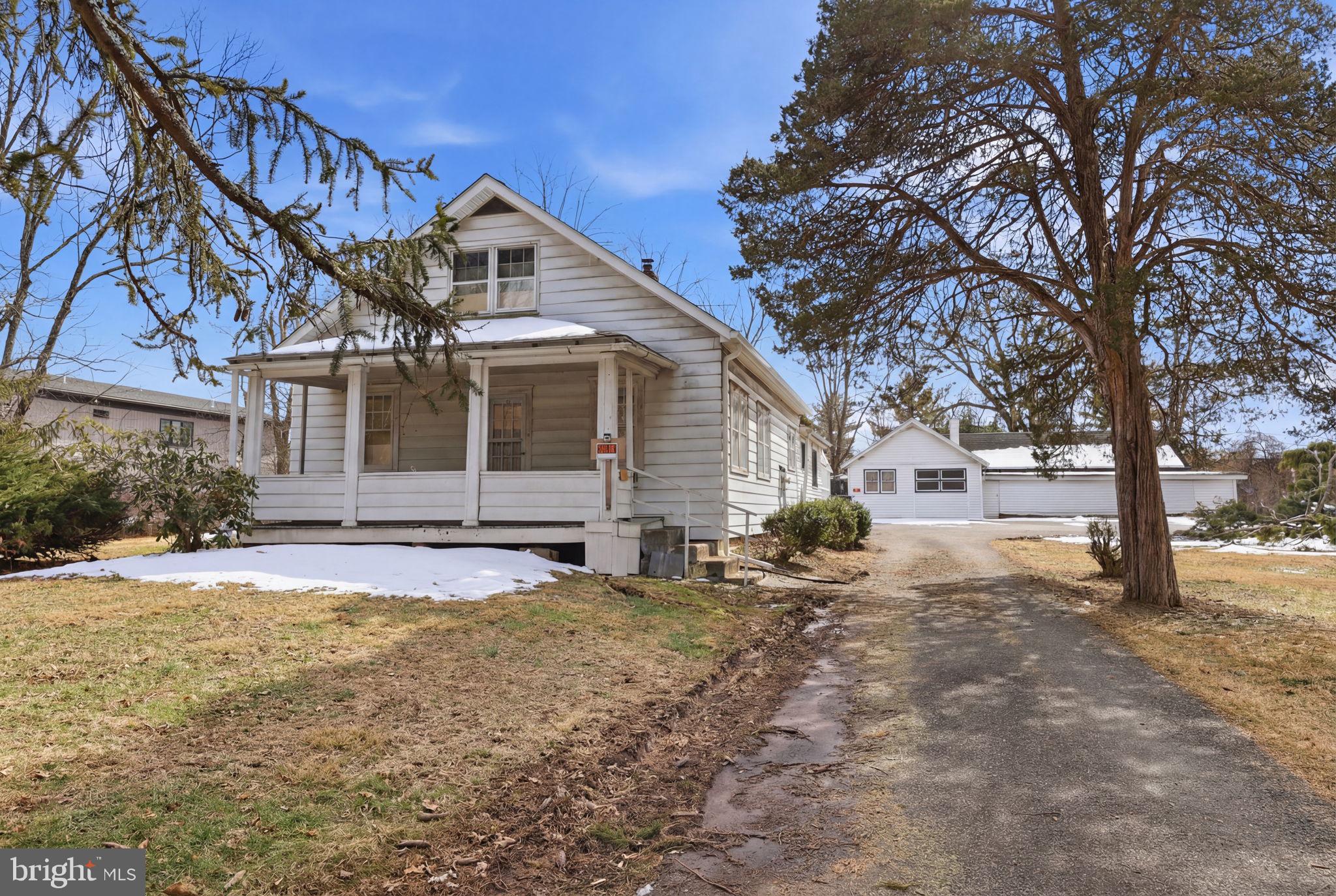 186 Pennington - Harbourton Road Pennington, NJ 08534 - Photo 12 of 20 a front view of a house with a yard covered in snow