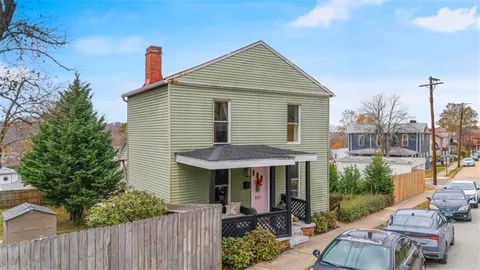 a view of a house with a yard and furniture
