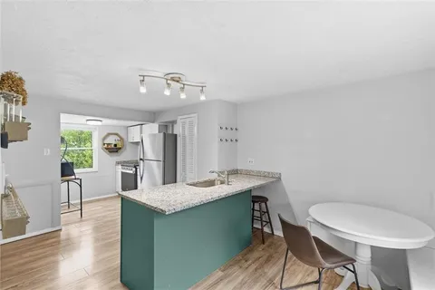 a dining room with furniture a window and wooden floor