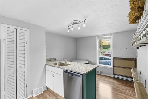 a utility room with faucet washer and dryer