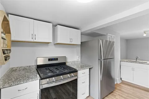 a kitchen with appliances cabinets and a counter space