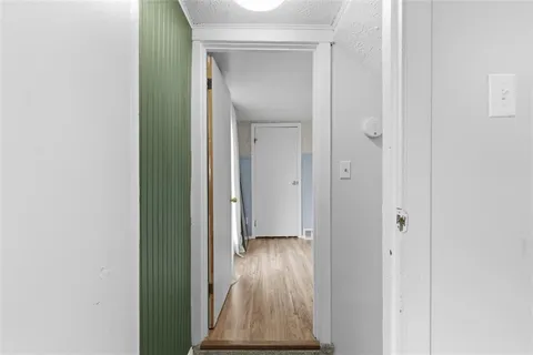 a view of hallway with wooden floor