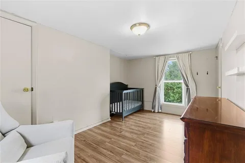 a bedroom with a bed and a large window