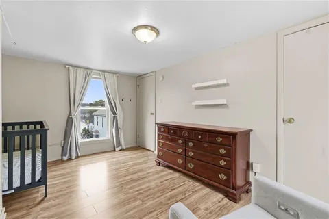 a room with a dresser and a window