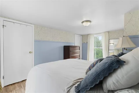 a bedroom with a large bed and a large window