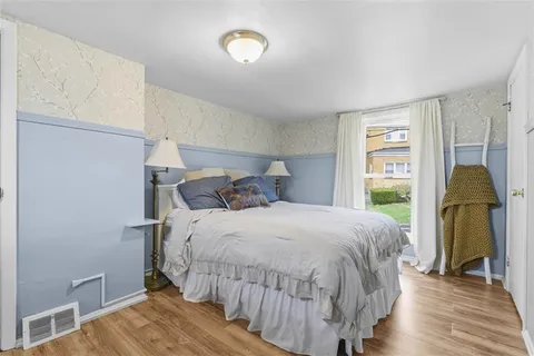 a bedroom with a bed and a window