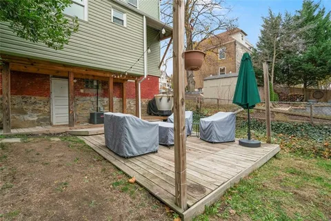 a view of a house with backyard and sitting area