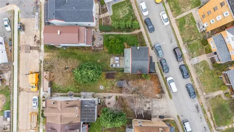a aerial view of a residential apartment building with a yard