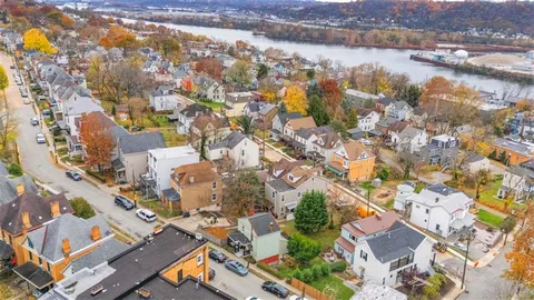 an aerial view of residential building with outdoor space and lake view