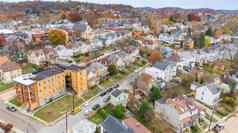 an aerial view of residential houses with outdoor space