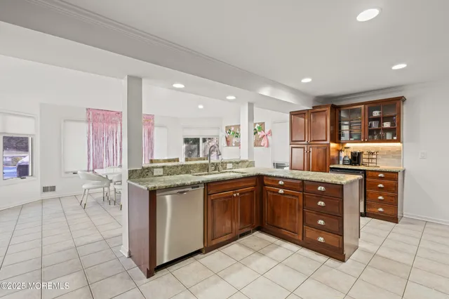 a kitchen with stainless steel appliances granite countertop a sink and cabinets