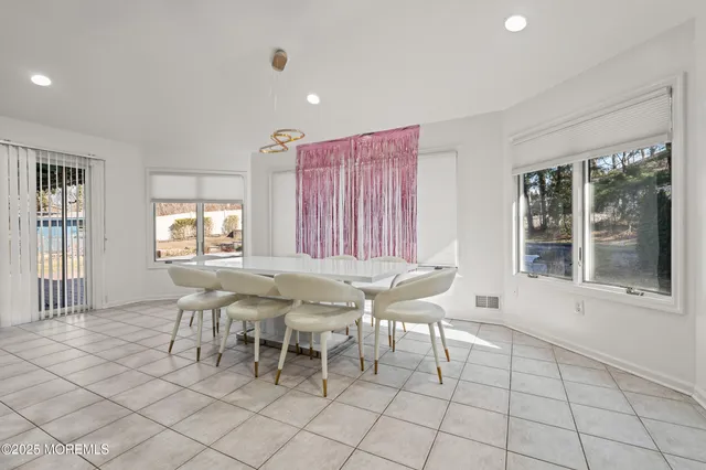 a dining room with furniture and window