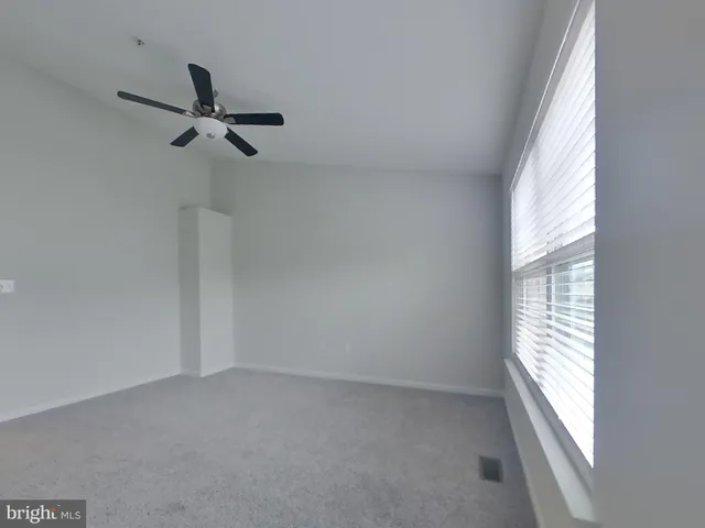 a view of an empty room and a window