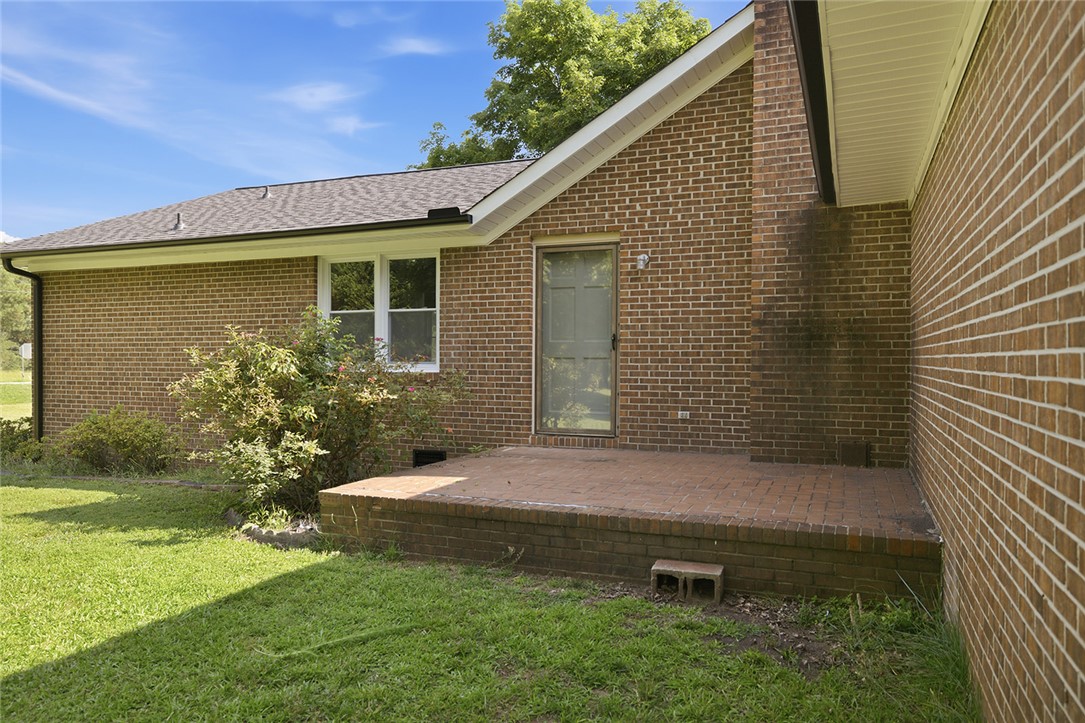 902 Cherokee Road Pelzer, SC 29669 - Photo 19 of 38 A brick patio adjoins the rear of this home, offering a quiet outdoor retreat.