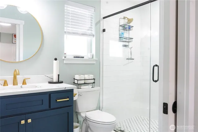 a bathroom with a sink a toilet and a mirror